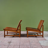 Pair of Arne Karlsen and Peter Hjort Leather and Cane Lounge Chairs